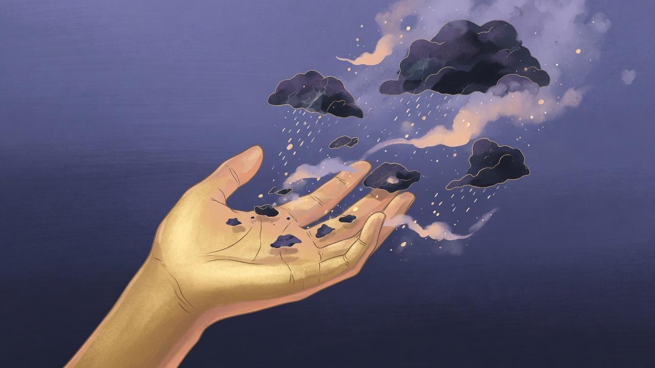 Calm open hand releasing dissolving storm fragments into light